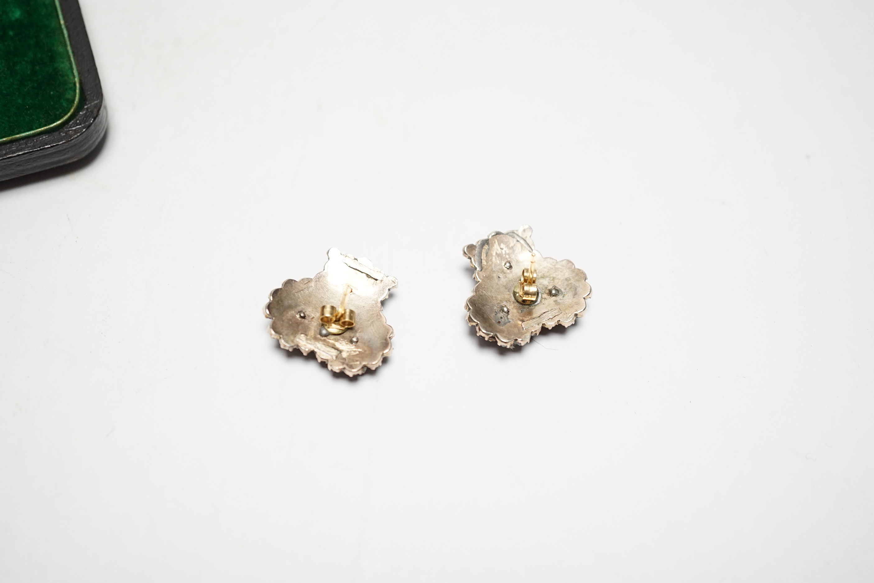 A pair of Edwardian gilt white metal and garnet coloured paste set triple cluster earrings, diameter 18mm.